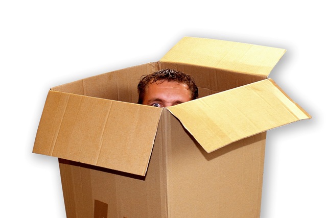 Man-peeking-out-of-moving-box.jpg